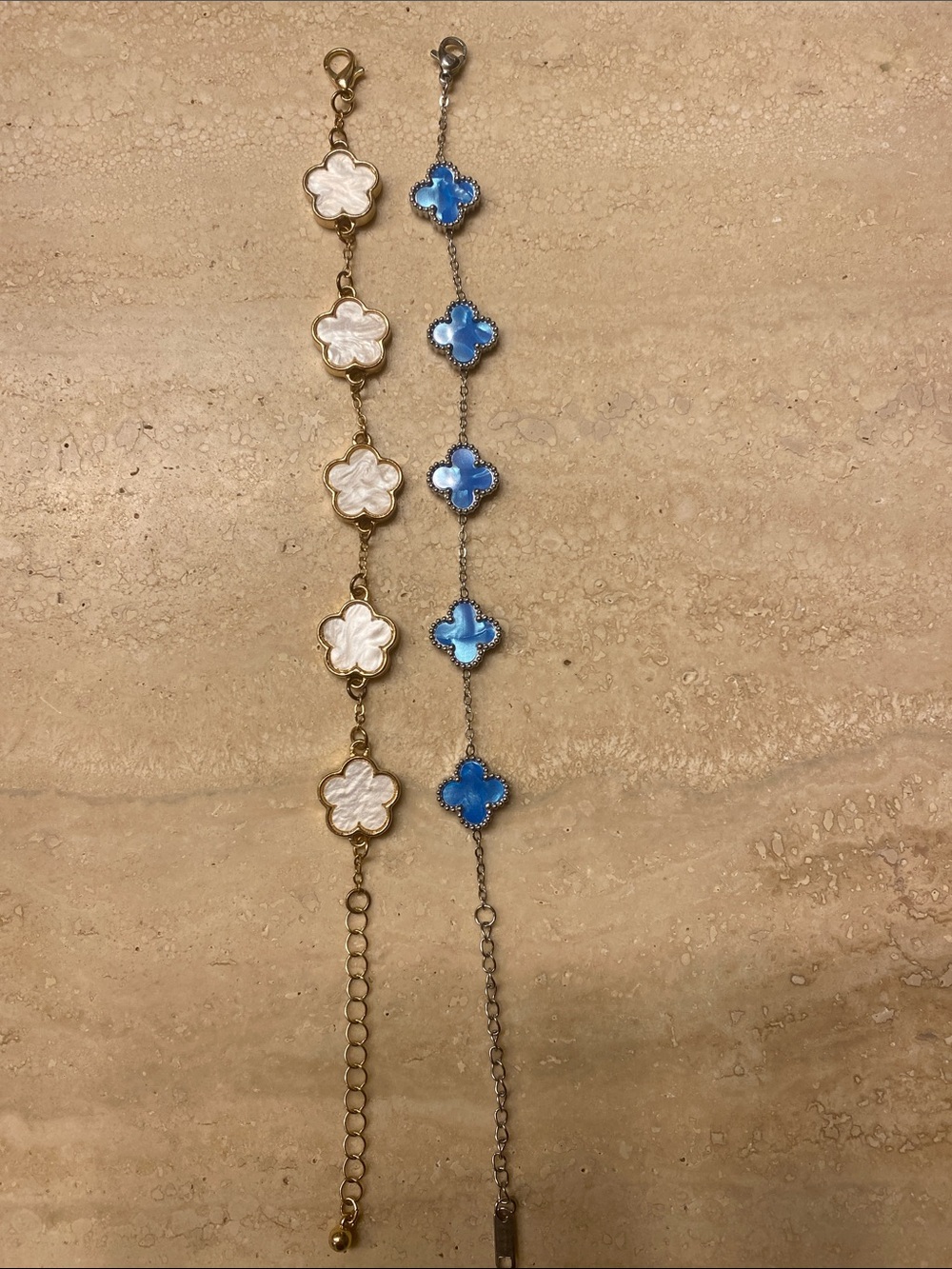 2 charm bracelets - blue and white clover-motif stations.
